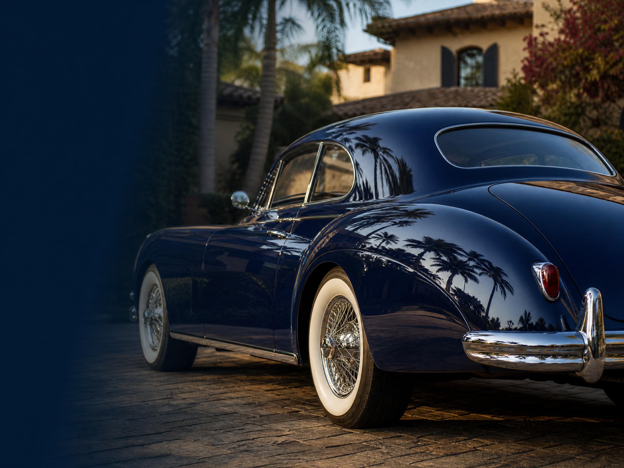 Immaculate navy classic car with mirror-like paint at a Southern California estate